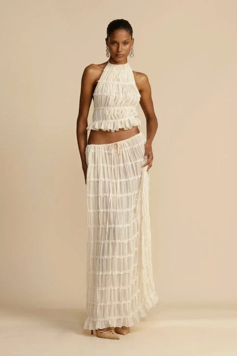 Miraee Paris two-piece set featuring a white pleated chiffon halter top and matching flowing maxi skirt.