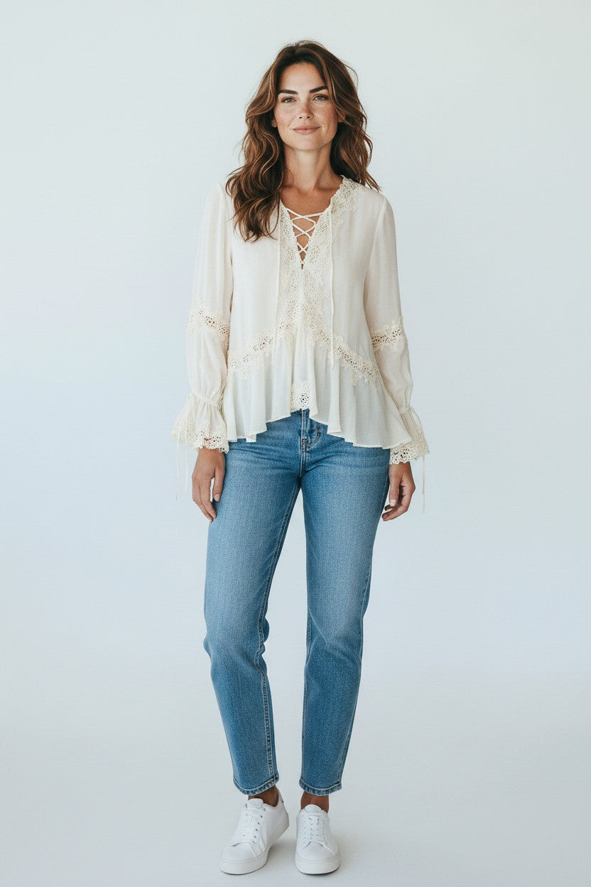 Miraee Paris cream lace blouse with V-neck, tie-front, and ruffled sleeves worn with blue jeans by a female model.