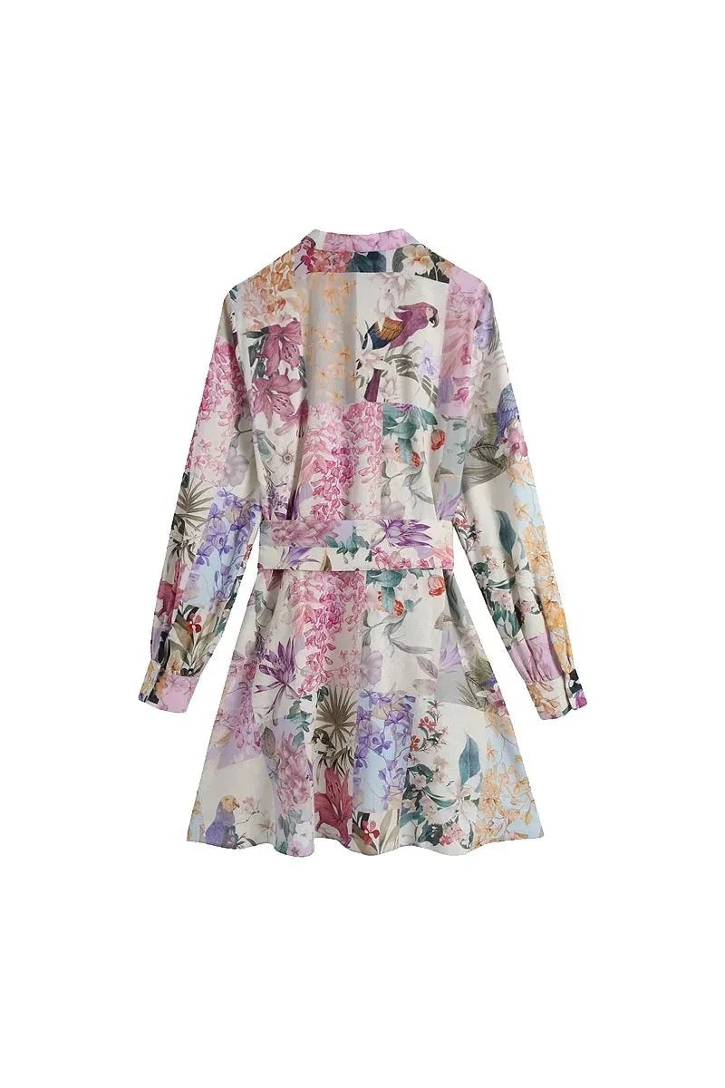 Miraee Paris Lena floral mini dress with long sleeves, button front, and waist belt in a vintage-inspired print.