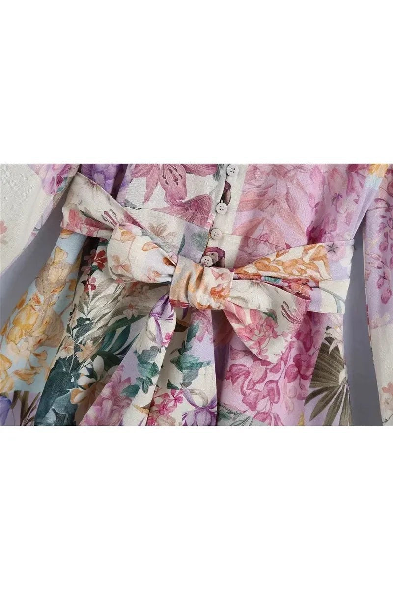 Miraee Paris Lena floral mini dress featuring a button-down front and a matching tie-waist belt in pastel tones.