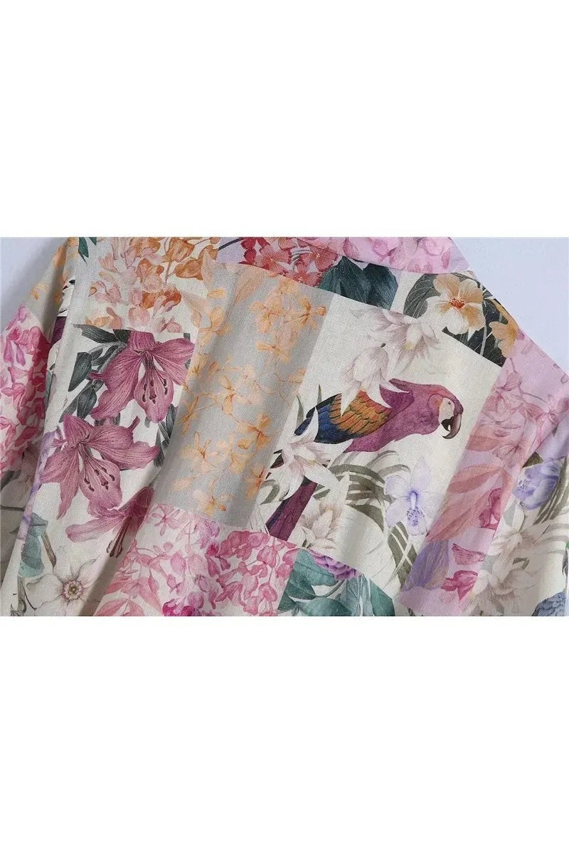 Miraee Paris Lena Floral Mini Dress featuring a vintage patchwork print with tropical flowers and a parrot motif.