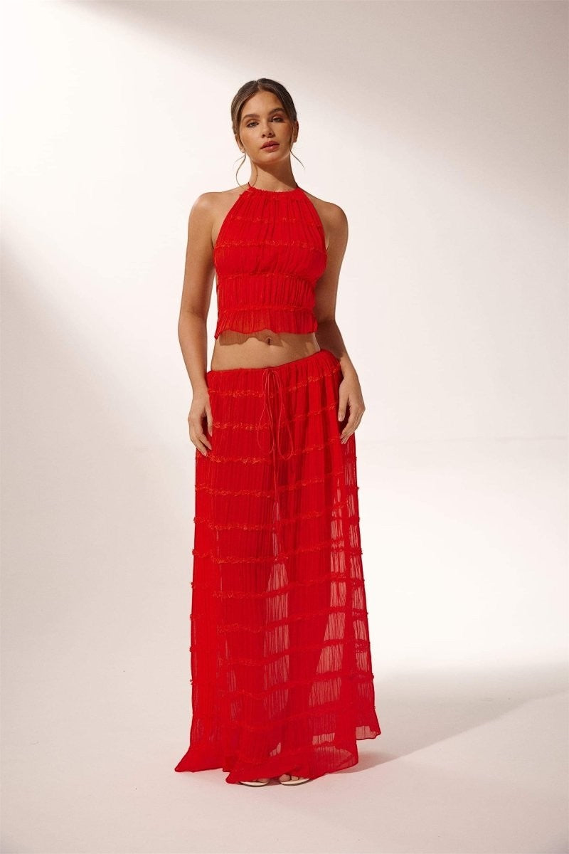 Miraee Paris red two-piece set featuring a pleated halter top and matching flowing maxi skirt in lightweight chiffon