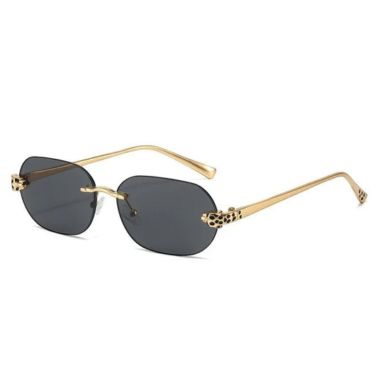 Miraee Paris Noir Panther rimless sunglasses with grey lenses, gold metal frames, and cheetah head side decorations.