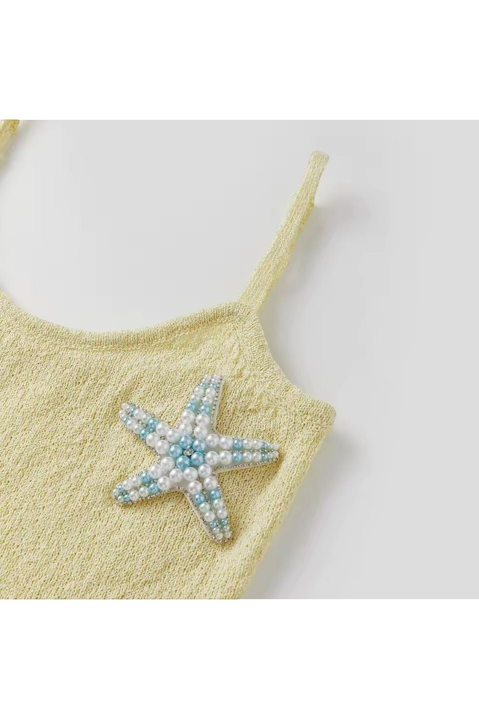 Miraee Paris Stella Mare lemon cream knit dress with a beaded starfish appliqué and delicate spaghetti straps.