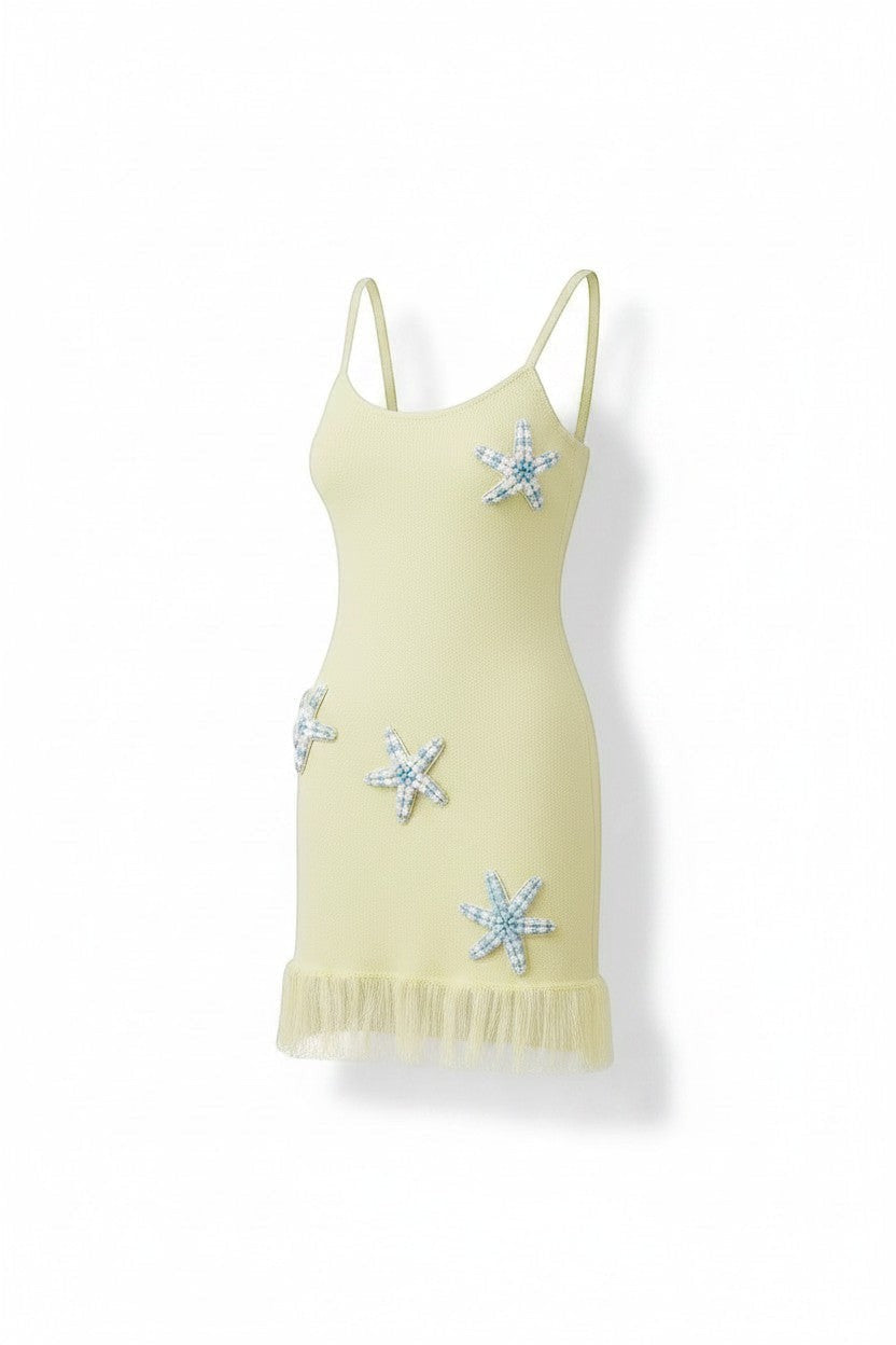 Miraee Paris Stella Mare lemon cream knit mini dress with spaghetti straps and decorative starfish embellishments.