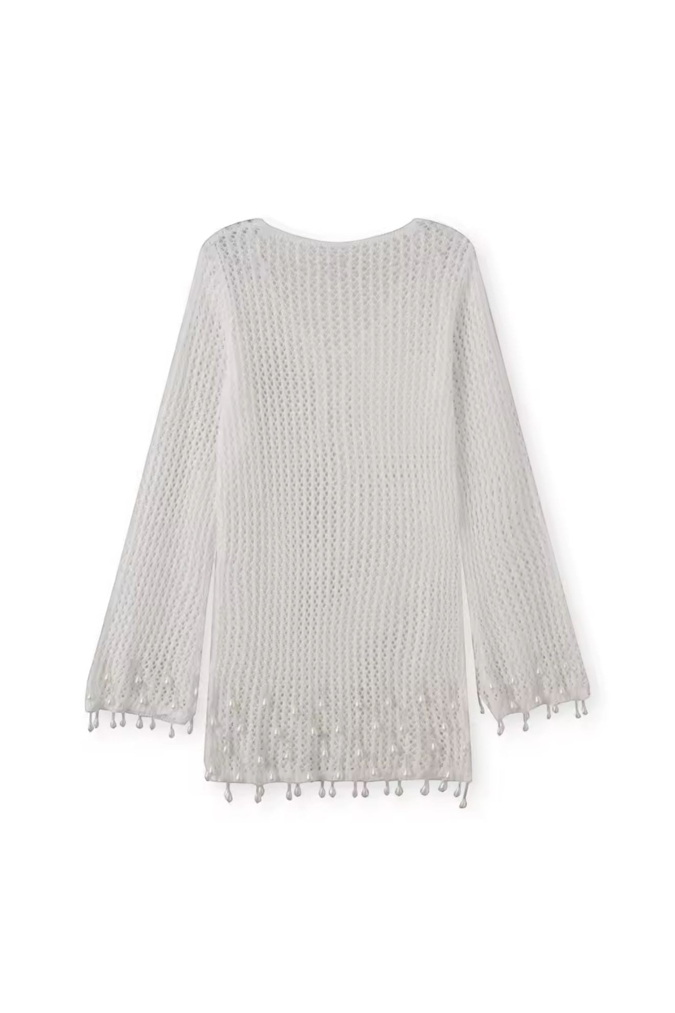 Miraee Paris white crochet beach cover-up with long sleeves and delicate tassel hem details in a breezy boho style.