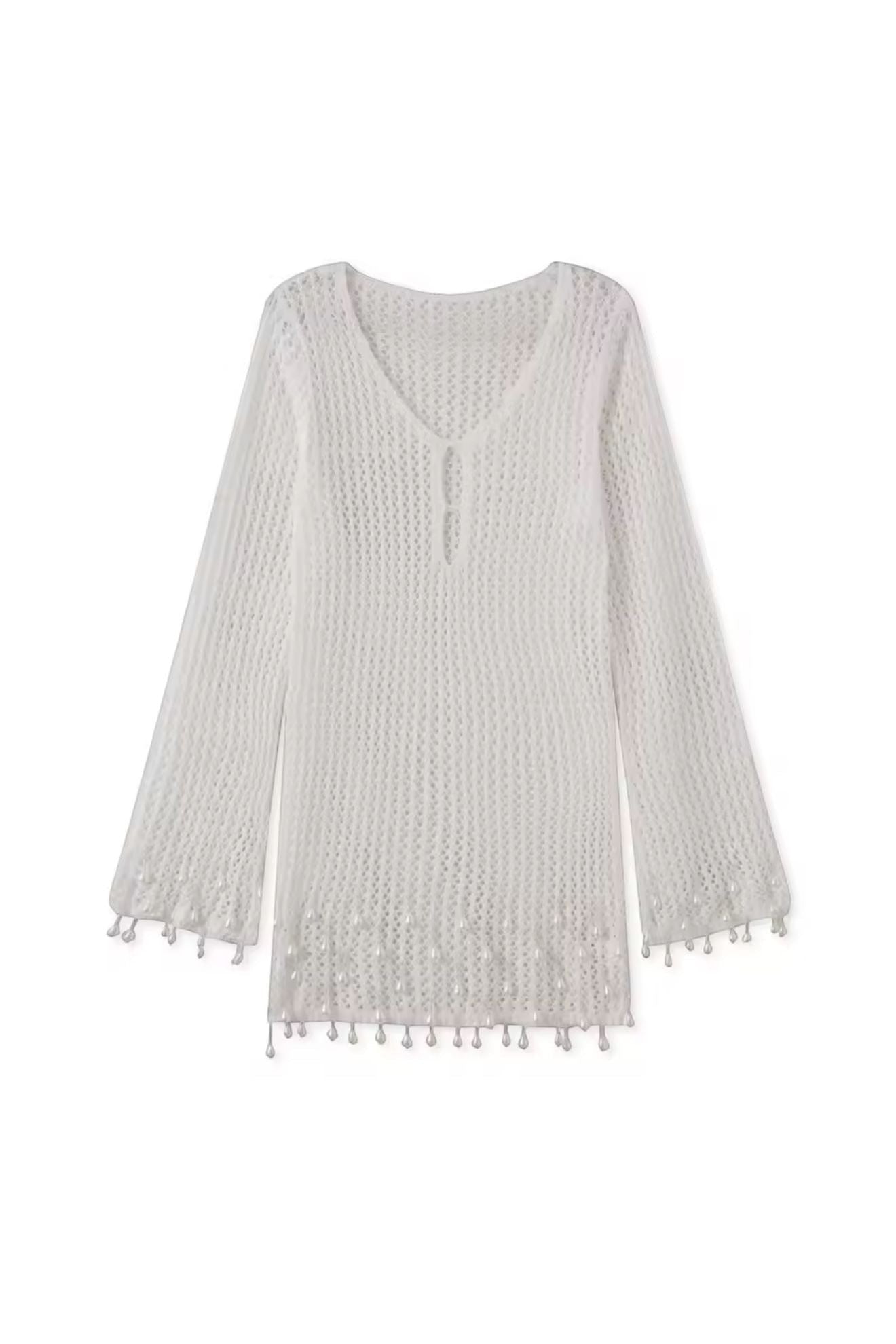 Miraee Paris white crochet beach cover-up with V-neck, long sleeves, and delicate tassel hem details.