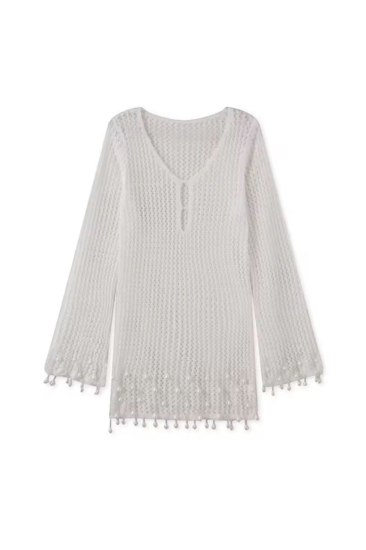 Miraee Paris white crochet beach cover-up with V-neck, long sleeves, and delicate tassel hem details.